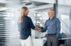 businessman and businesswoman shaking hands